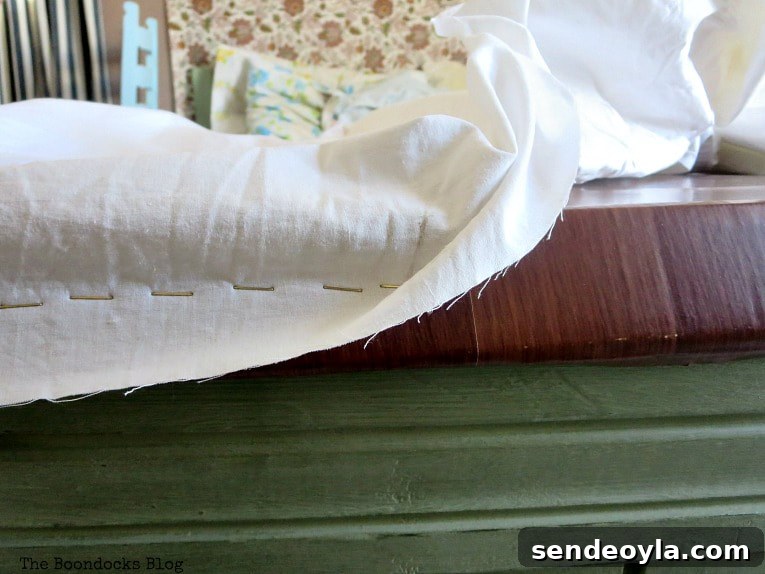 DIY Clothes Rack Cover: Step-by-Step Guide 7 Stapling the sheets onto the cardboard.