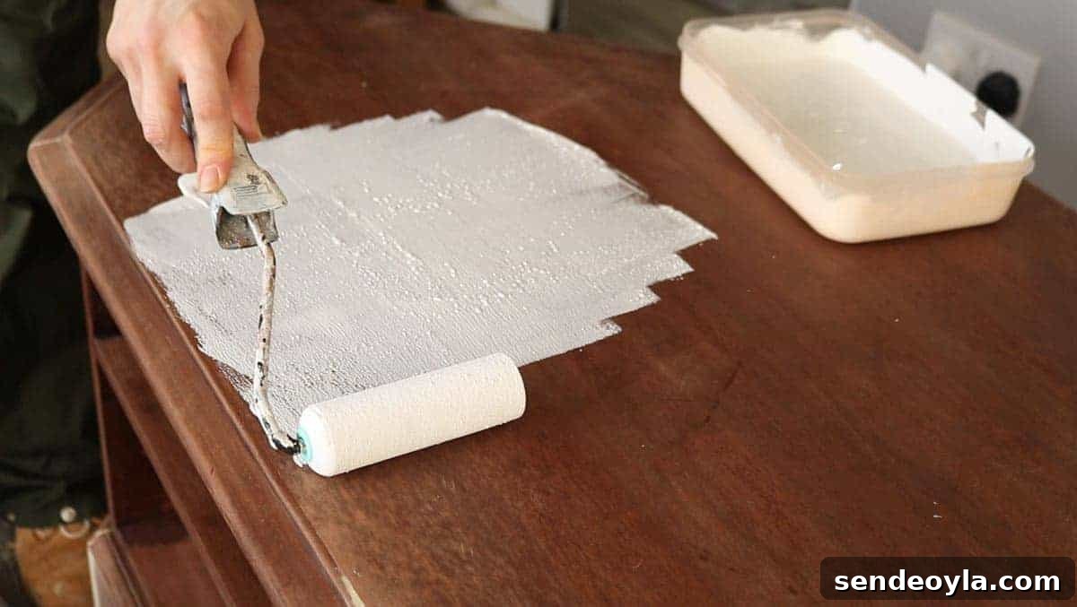 applying chalk paint with a mini foam roller