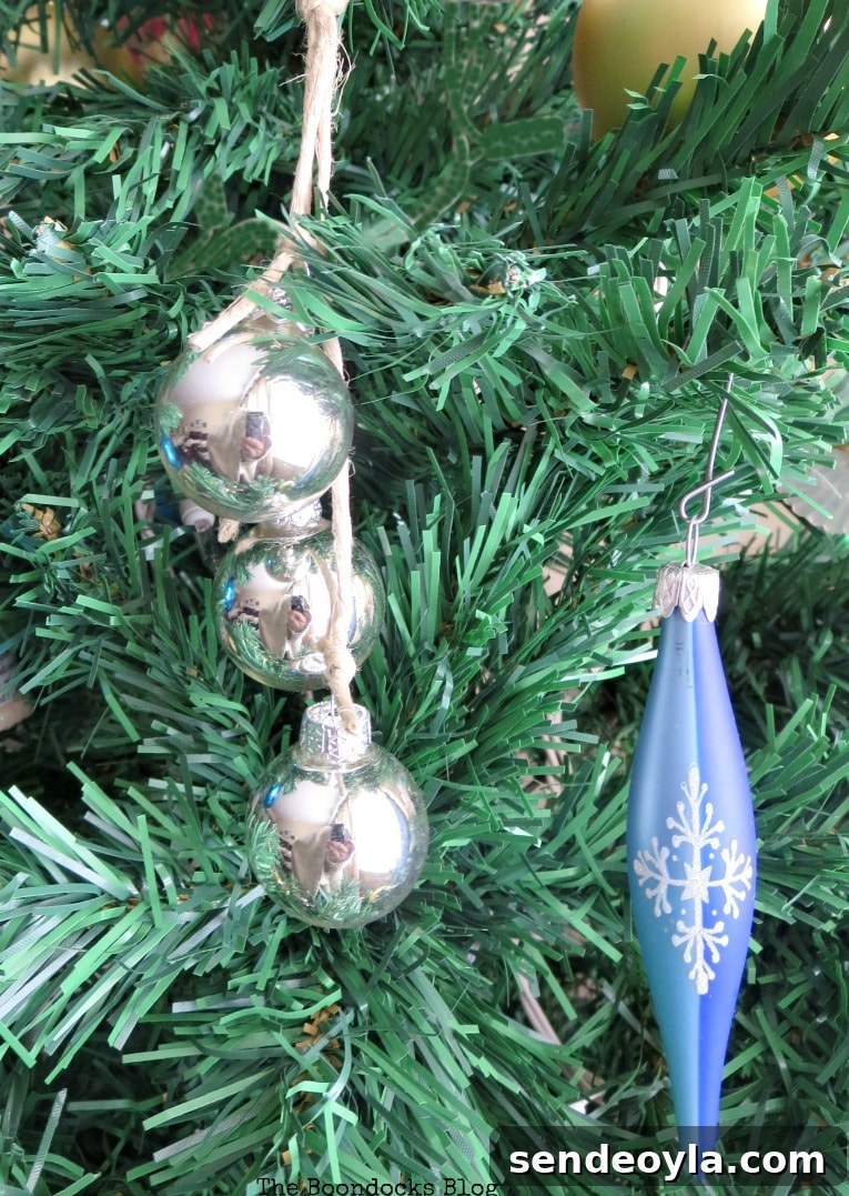 Silver globes grouped in 3 with jute and blue icicle ornament