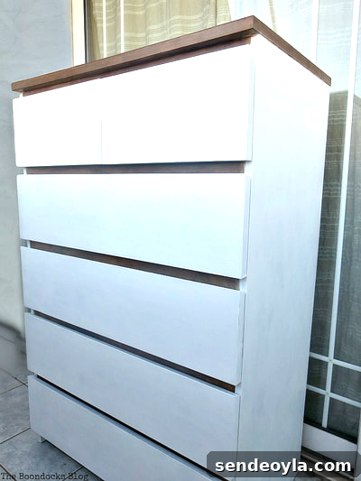 Finished IKEA Malm dresser makeover, painted in walnut and white colors.