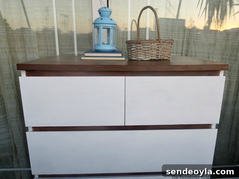 Finished dresser with basket, blue lantern and two books placed on top.
