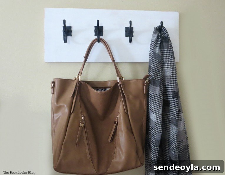 DIY Farmhouse Coat Rack for Your Entryway 11 bag and scarf hanging from hooks, How to Make a Wooden Wall Hanger www.theboondocksblog.com