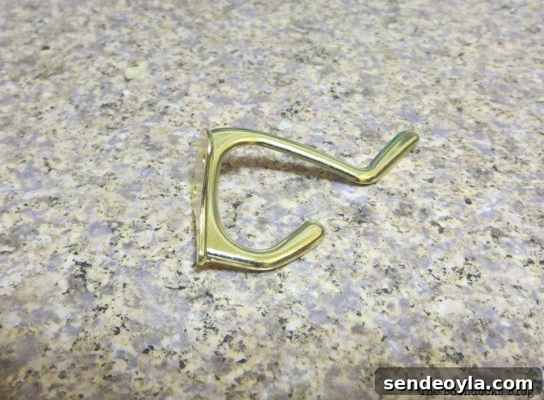 DIY Farmhouse Coat Rack for Your Entryway 6 the wrong hook, fake gold, How to Make a Wooden Wall Hanger www.theboondocksblog.com