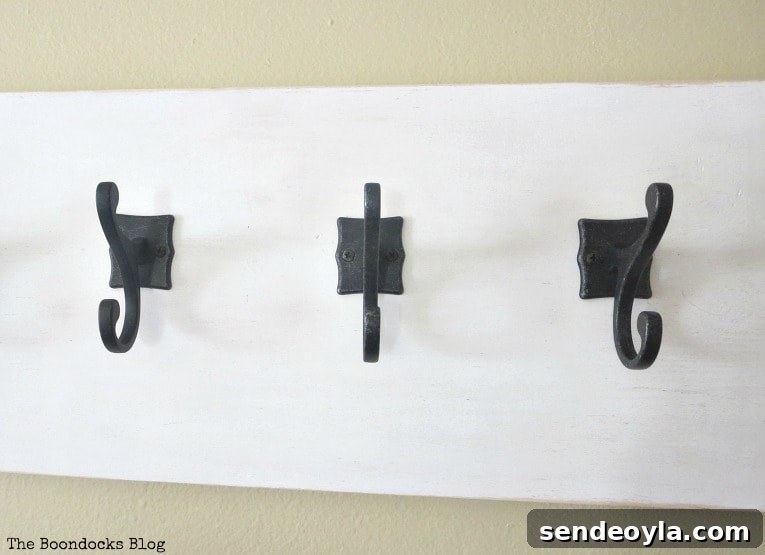 DIY Farmhouse Coat Rack for Your Entryway 7 Gunmetal hooks on wood, How to Make a Wooden Wall Hanger www.theboondocksblog.com