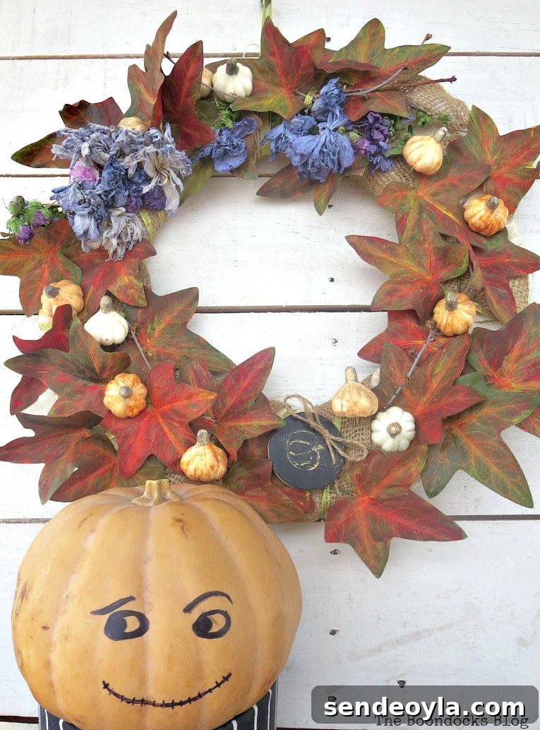 How to Turn a Dollar Store Vine into a Fall Wreath 18 pumpkin man next to the fall wreath