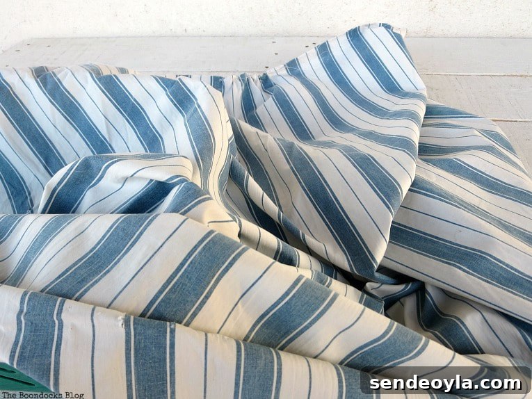 Upcycle Broken Plastic Baskets into Fabric Storage Bins 4 Blue striped piece of fabric.