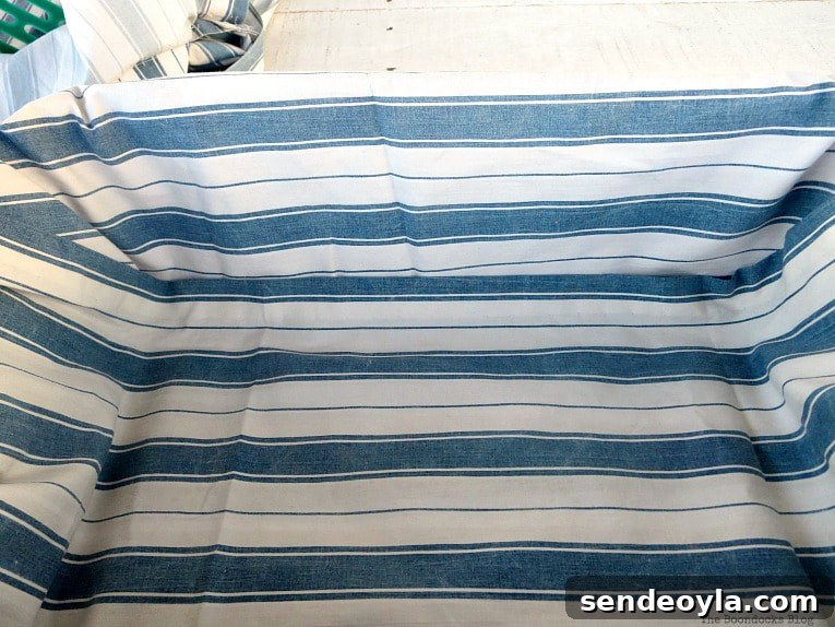 Upcycle Broken Plastic Baskets into Fabric Storage Bins 7 Folding the fabric on the other side over the basket.