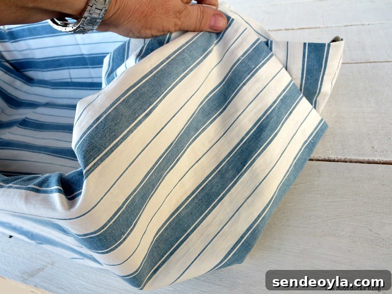Upcycle Broken Plastic Baskets into Fabric Storage Bins 8 Folding the ends of the fabric.