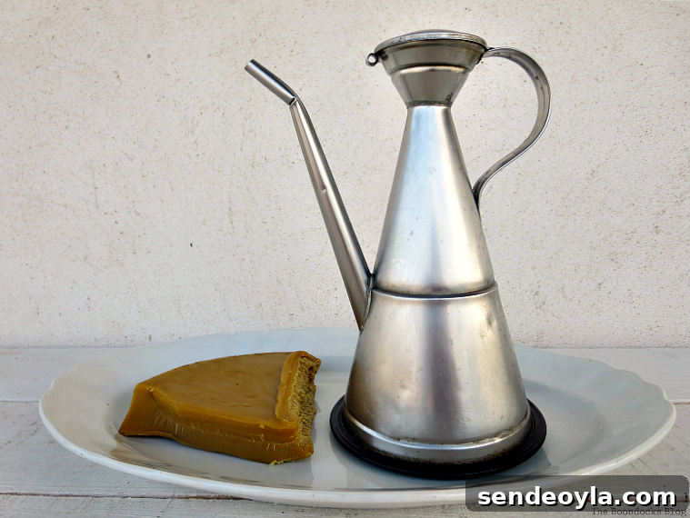 DIY Beeswax Furniture Polish Recipe and Care Tips 3 Piece of beeswax and tin of olive oil placed on a plate.