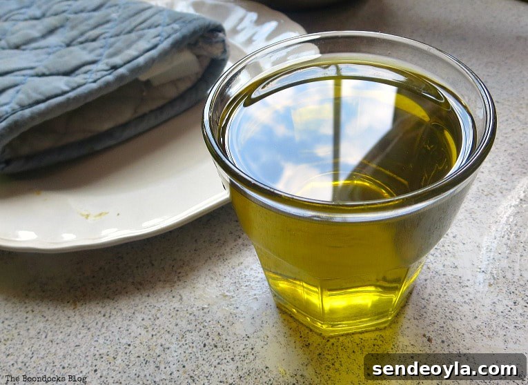 DIY Beeswax Furniture Polish Recipe and Care Tips 5 Olive oil in a glass cup.