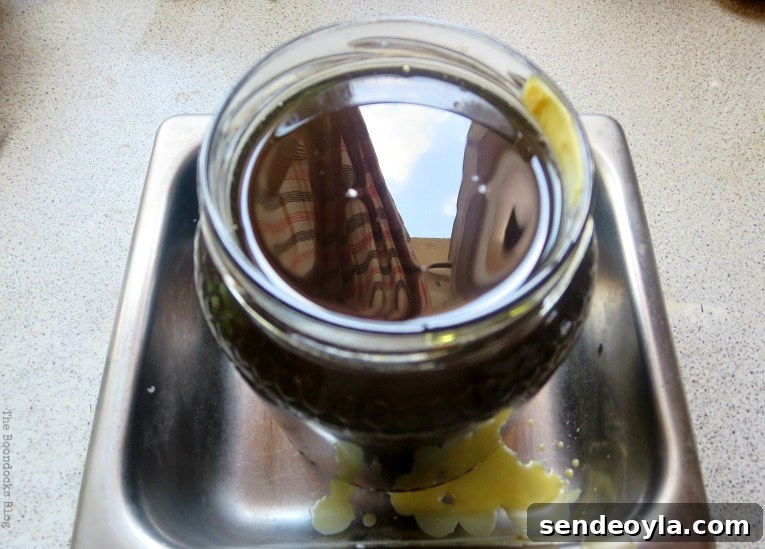 DIY Beeswax Furniture Polish Recipe and Care Tips 9 Beeswax mixture poured into jar.