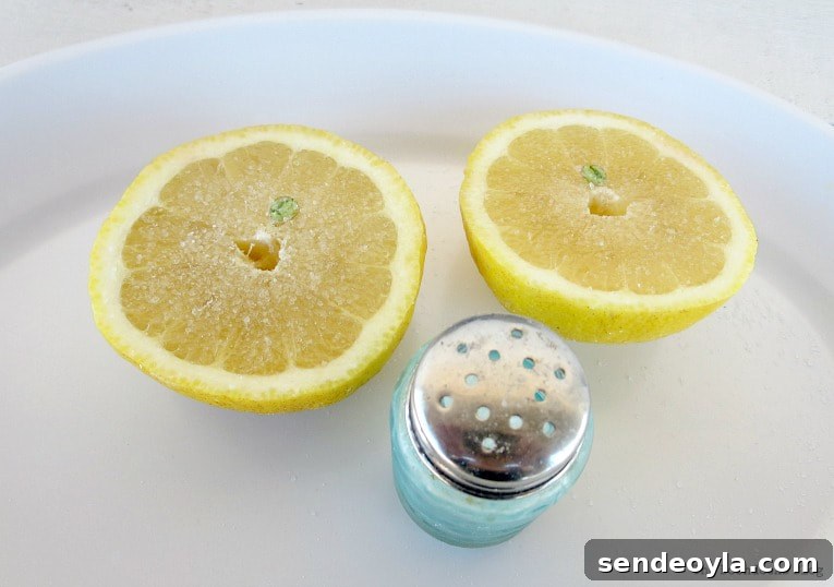 Upcycling Vintage Copper Pots: Mistakes to Avoid 4 A lemon cut in half and a salt shaker.