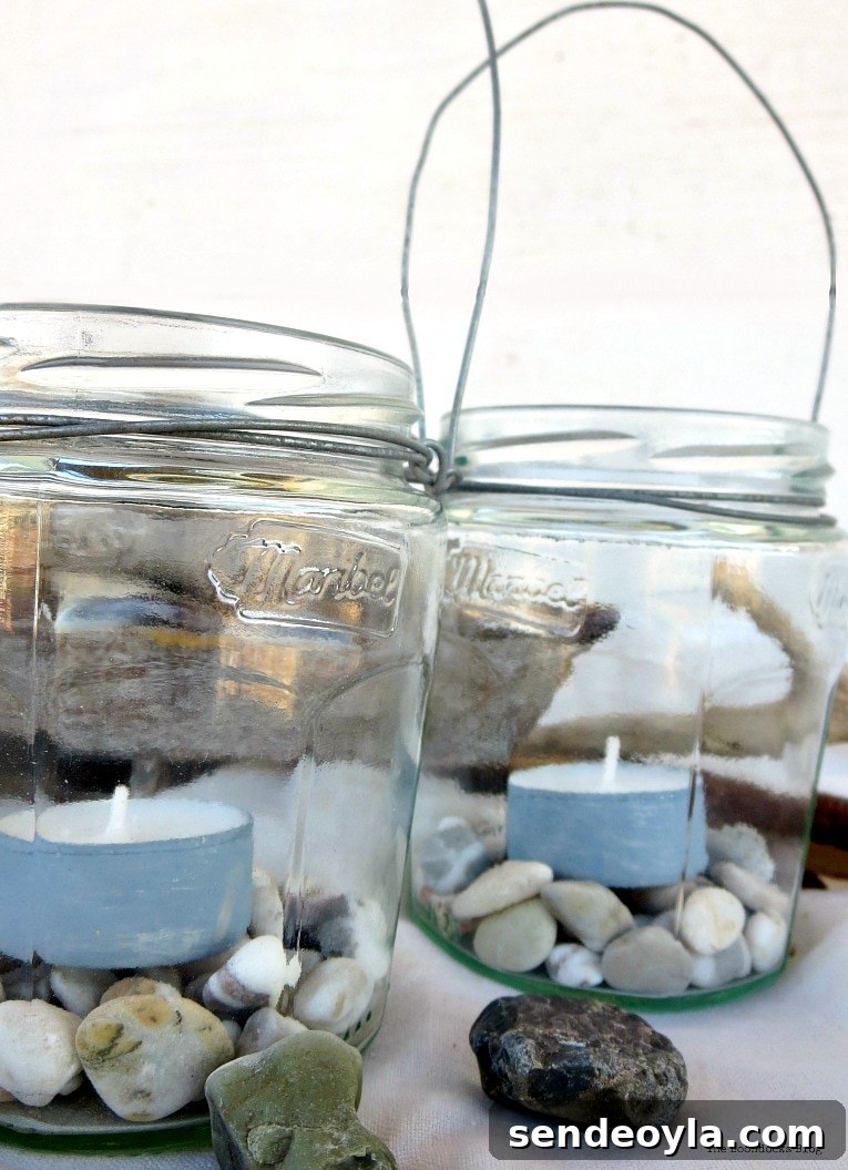 two lantern jars with tea lights and pebbles
