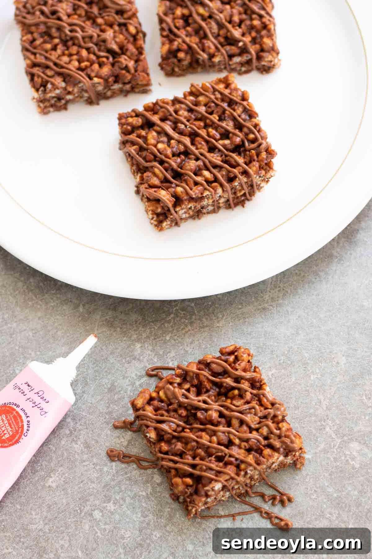 drizzling chocolate on rice krispies treat squares