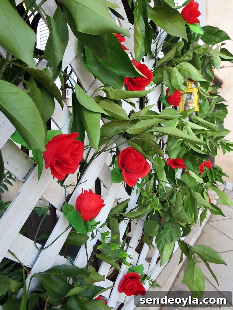 DIY Colorful Fence with Dollar Store Flowers 12 Greenery and faux flowers on the lattice flower wall.