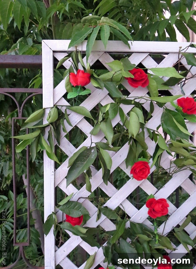 DIY Colorful Fence with Dollar Store Flowers 13 Corner view of lattice flower wall and greenery.