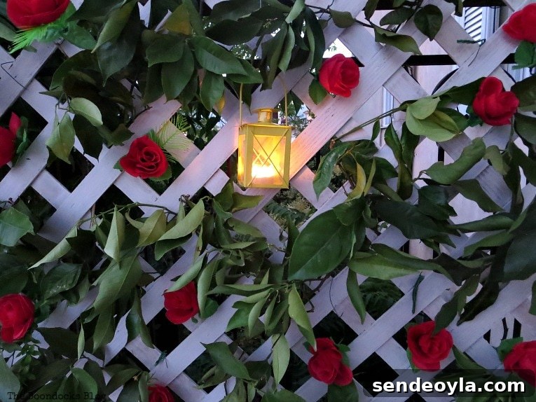 DIY Colorful Fence with Dollar Store Flowers 14 Lit tea light lantern on lattice flower wall.