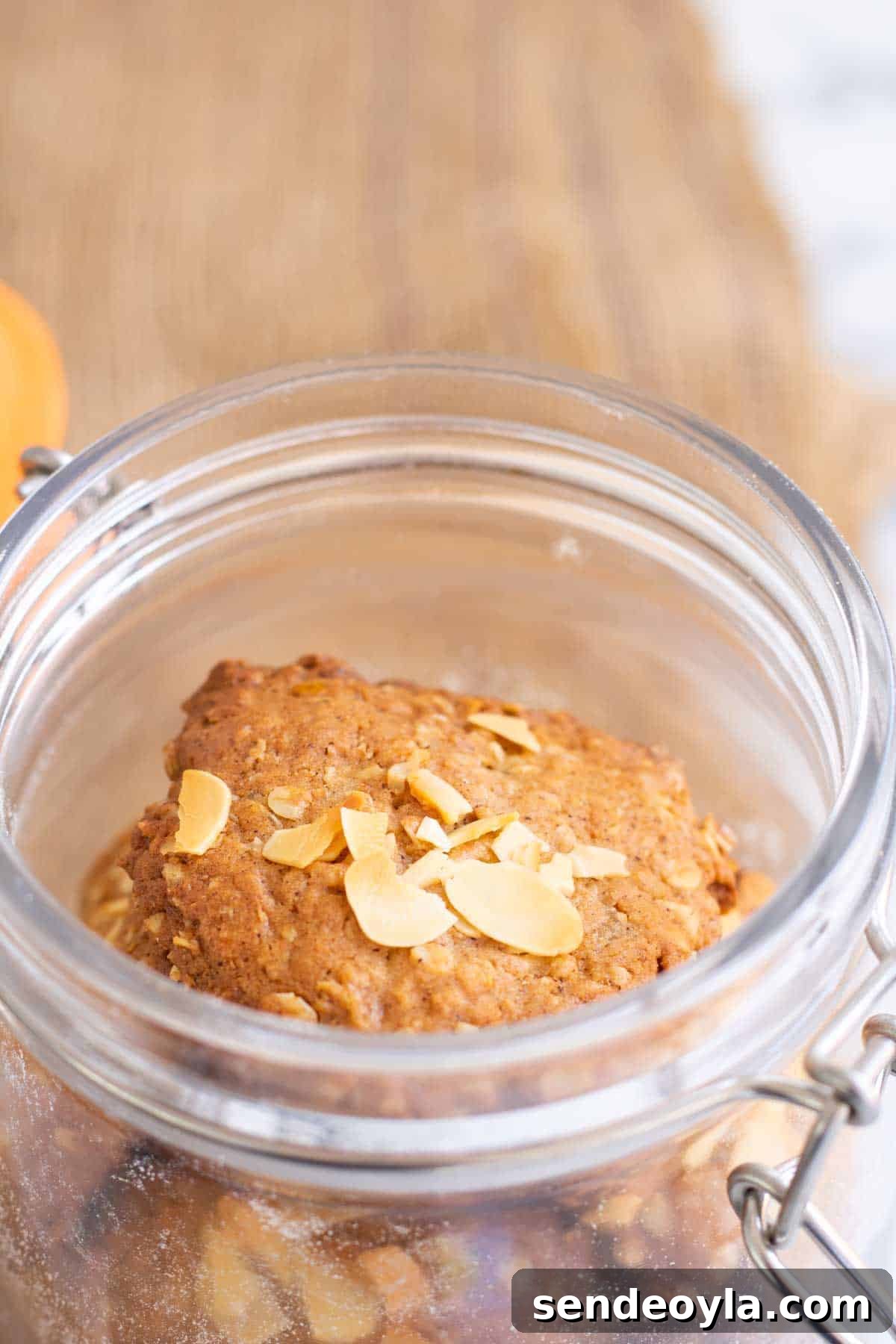 Classic Crunchy Anzac Biscuits Recipe 4 easy biscuit recipe in a cookie jar topped with almonds