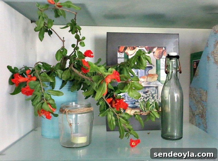 Pomegranate branches added for color to the shelf, Pretty and Practical Bookcases the Easy Way