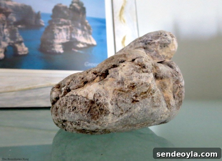 Avoid These Mistakes When Upcycling Bookcases 12 Stone in front of framed postcard with rock formation.
