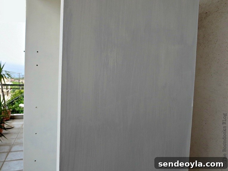 Avoid These Mistakes When Upcycling Bookcases 10 Adding the custom gray color to the exterior of the bookcase.