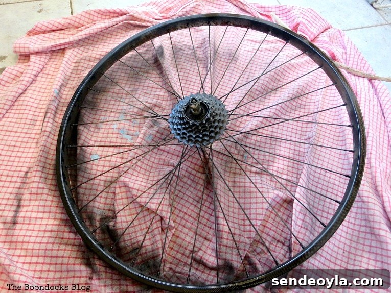 spray painting the tire rim, How to Re-purpose a tire rim into a Unique wind chime - Int'l Bloggers Club