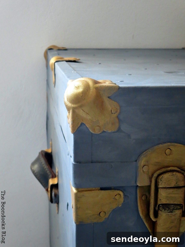 Applying beeswax to seal the paint on the trunk.