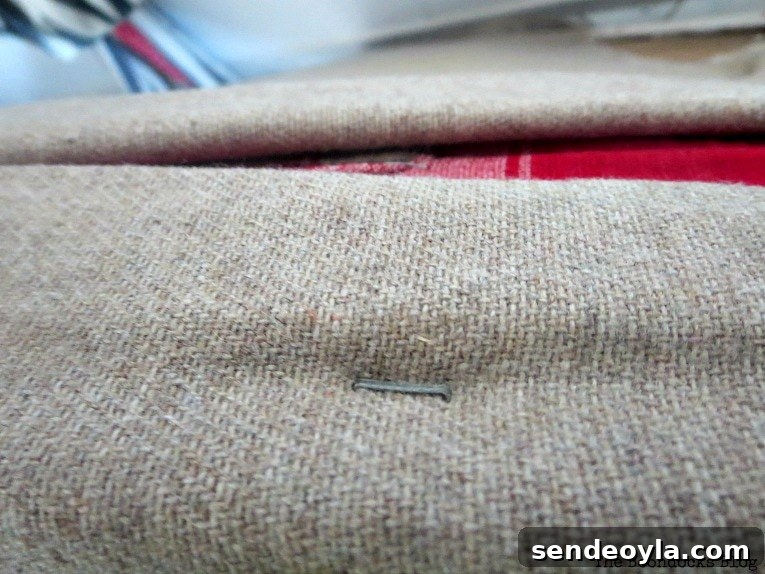 stapling the fabric onto the plywood, How to Easily Warm up a Room with Fabric