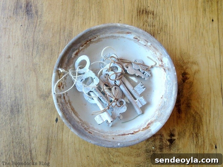 dish with painted keys, How to Make Simple Canvas Wall Art with Keys, www.theboondocksblog.com