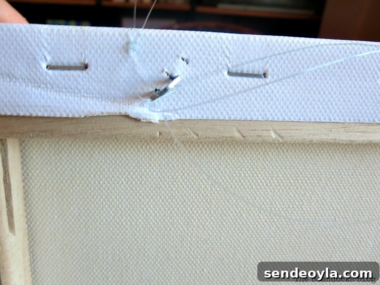 staple which juts out of back of canvas, How to Make Simple Canvas Wall Art with Keys, www.theboondocksblog.com