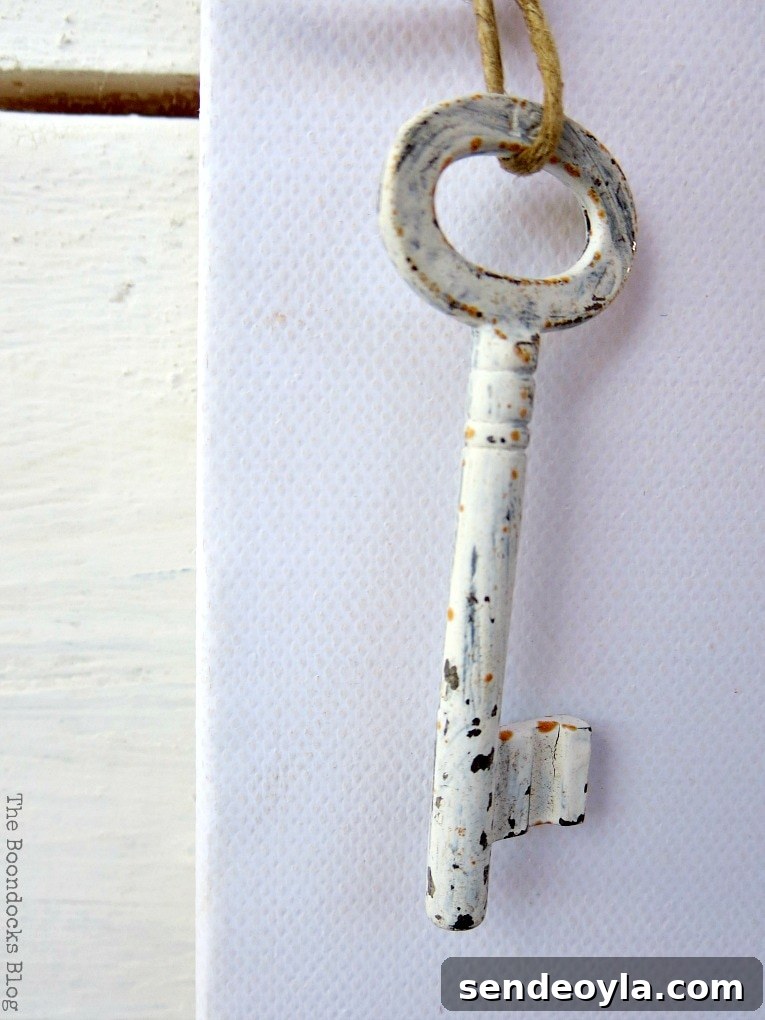 cool chalky painted key full of rust and patina, How to Make Simple Canvas Wall Art with Keys, www.theboondocksblog.com