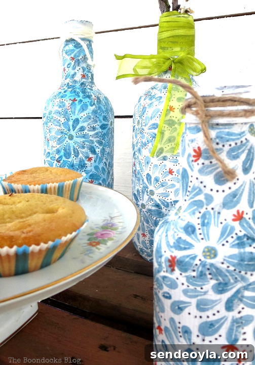 Three plastic bottles covered with pretty napkin paper using decoupage.