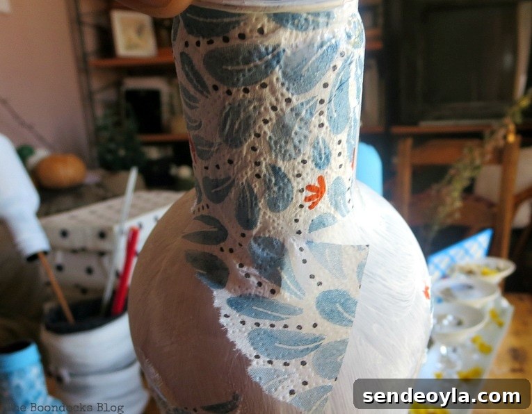 Decoupaging napkins on top of chalk painted plastic bottles.