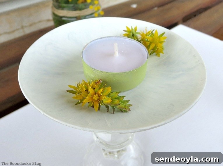 DIY Spring Pedestal from Upcycled Cordial Glasses and Saucers 12 Painted tealight with yellow succulent flowers sitting on the painted saucer.