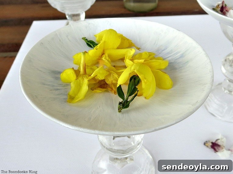 DIY Spring Pedestal from Upcycled Cordial Glasses and Saucers 13 Yellow flowers on painted saucer.