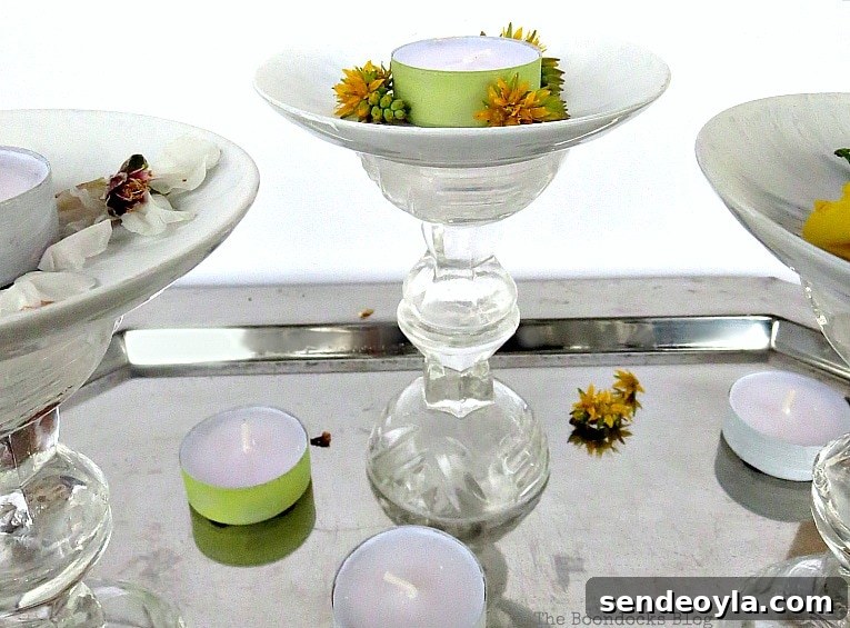 DIY Spring Pedestal from Upcycled Cordial Glasses and Saucers 15 Pedestals placed on a silver tray with tea lights and flowers.