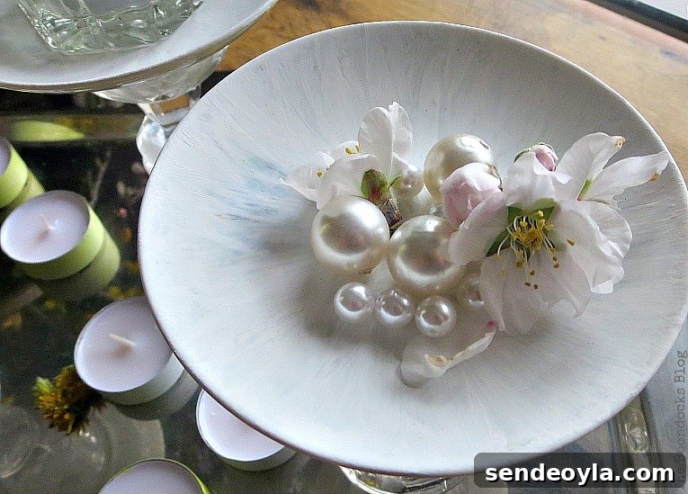DIY Spring Pedestal from Upcycled Cordial Glasses and Saucers 16 Top view of the painted saucer with a flower and faux pearls placed in it.
