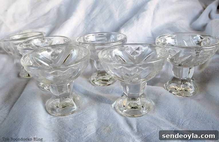 DIY Spring Pedestal from Upcycled Cordial Glasses and Saucers 6 Six cordial glasses sitting on a white sheet.