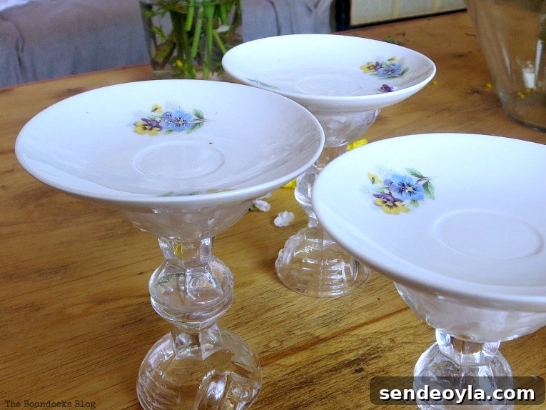 DIY Spring Pedestal from Upcycled Cordial Glasses and Saucers 8 Gluing saucers on top of the glass pedestals.