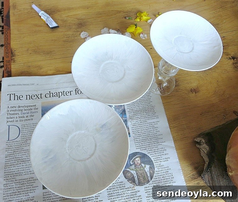 DIY Spring Pedestal from Upcycled Cordial Glasses and Saucers 9 Painting the saucers with white paint.