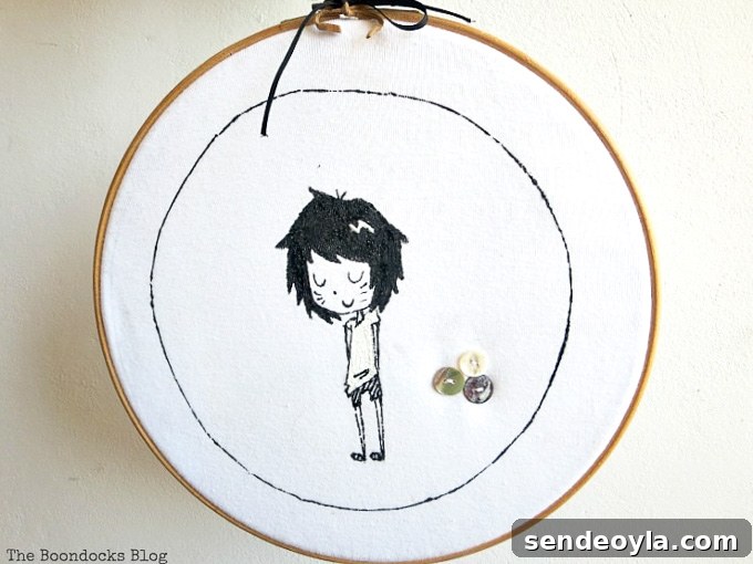 DIY T-Shirt Wall Art: Transform a Tee into Home Decor 2 upcycled tshirt placed into the embroidery hoop and hung on the wall.