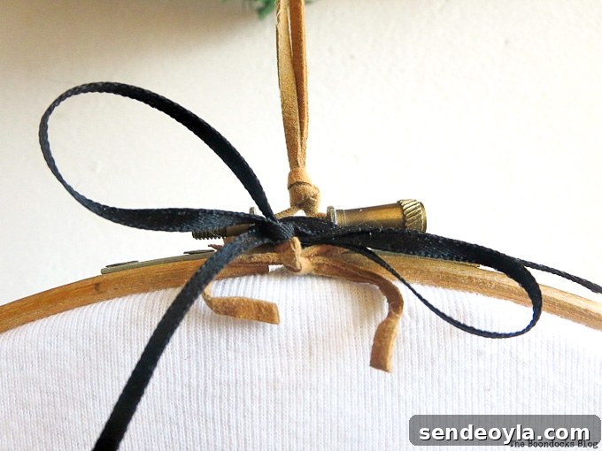 DIY T-Shirt Wall Art: Transform a Tee into Home Decor 7 Cord and ribbon added to the top of the hoop.