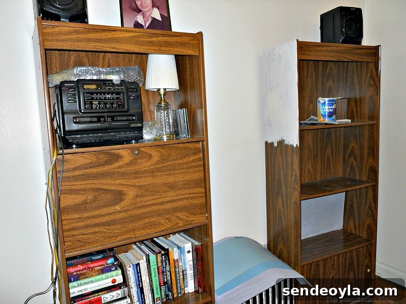 Transform Bookcases with Paint and Wrapping Paper 4 Starting to paint the bookcase white.