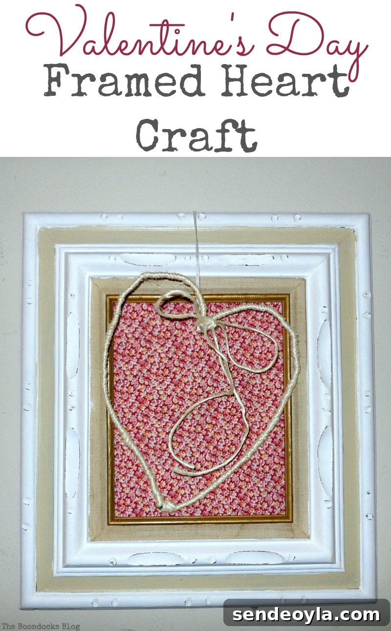 Wire heart wrapped in twine and hung over a frame covered in red fabric
