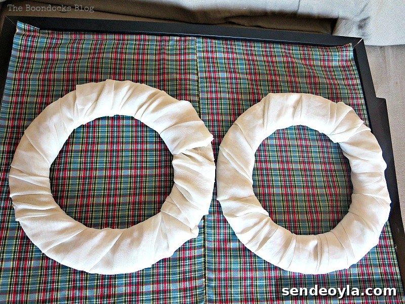 Wrapping the chiffon fabric around the donut shapes to make wreaths, Christmas Picture Frames with Wreaths the Lazy Way www.theboondocksblog.com