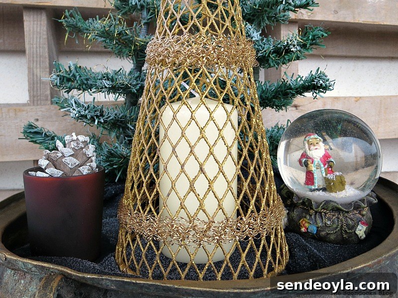 a white candle is placed under the gold tree, A repurposed Antique Cauldron for Christmas theboondocksblog