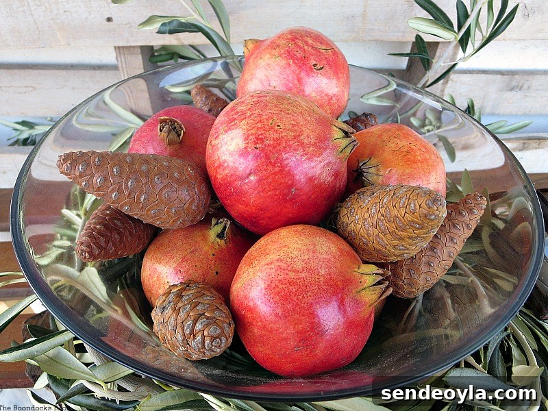 DIY Natural Thanksgiving Table Centerpiece Ideas 11 Overhead view of glass bowl filled with pomegranates and pine cones.