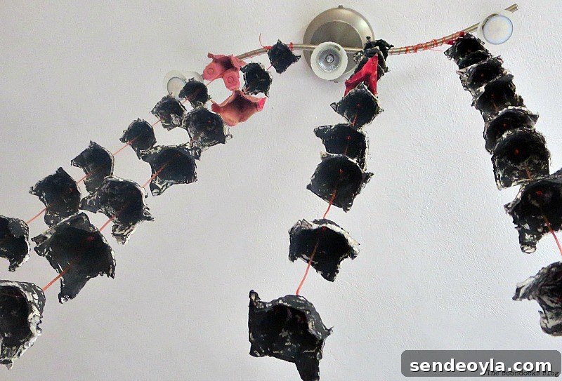 Back egg cartons hanging from light fixture, Paranoid Man goes to the Halloween Party