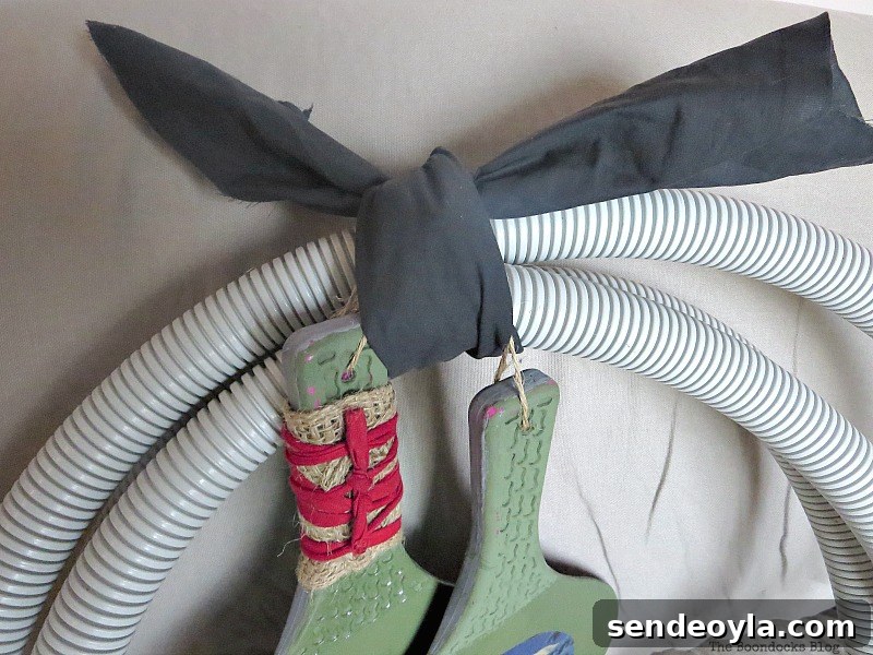 Adding fabric to hide cable ties, How to make a fun tube Halloween Wreath www.theboondocksblog.com