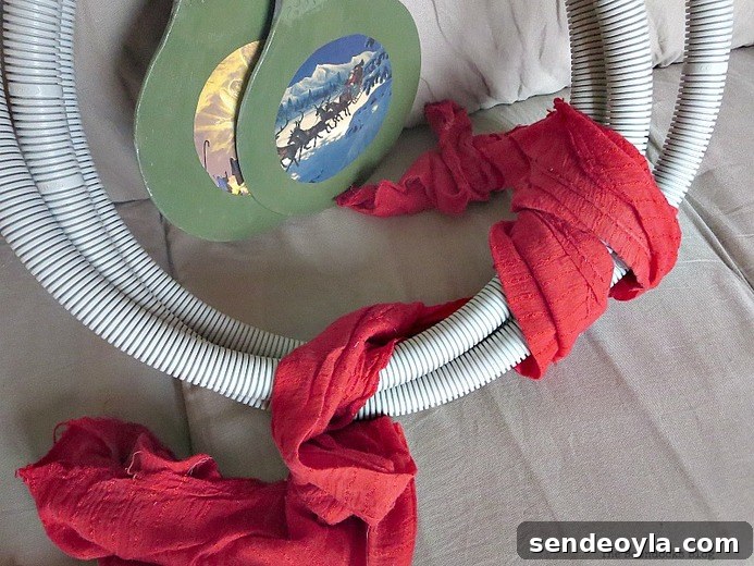 wrapping fabric around the tube, How to make a fun tube Halloween Wreath www.theboondocksblog.com